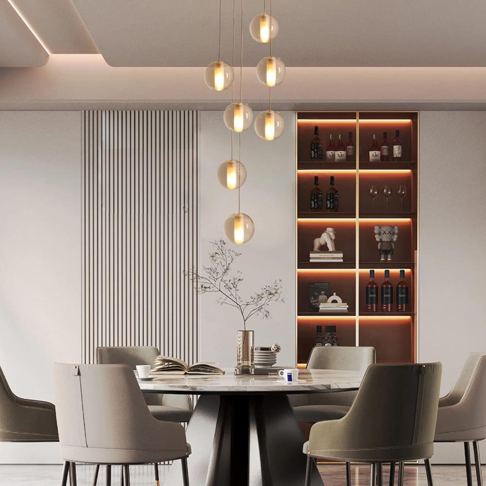 7-light cascading round base crystal chandelier illuminating modern round dining table and illuminated wine display