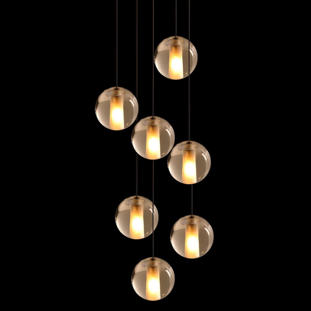 7-light cascading crystal bubble pendant light illuminated against dark background showing warm ambient LED glow