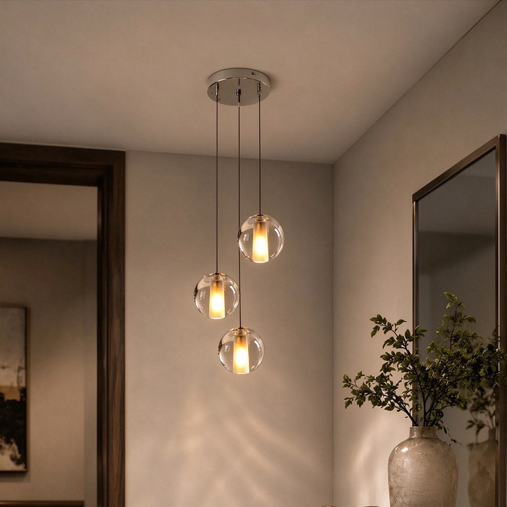 Modern 3-light crystal bubble ball pendant chandelier with round chrome canopy hanging beside bedroom and mirror