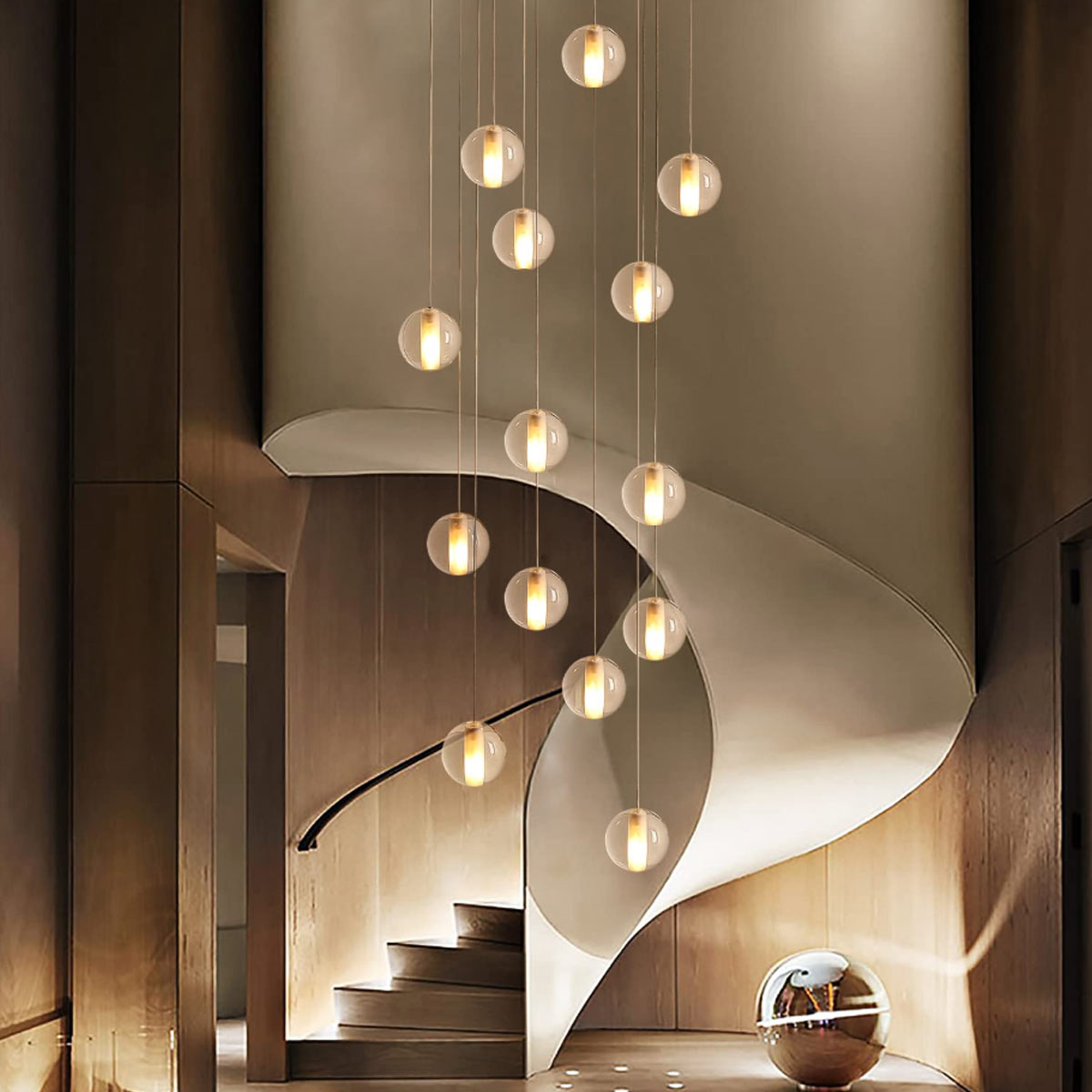 14-light cascading spiral crystal bubble chandelier gracefully hanging along a curved residential staircase
