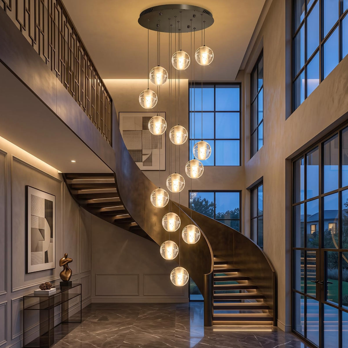 Grand 14-light cascading spiral crystal globe chandelier in a luxury double-height foyer with curved staircase