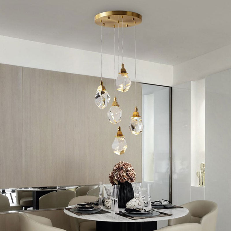 Diamond crystal chandelier with warm gold-tone hardware in a contemporary foyer setting