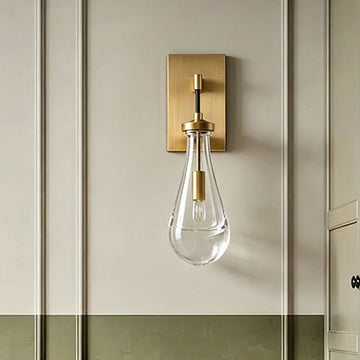 Single modern brass gold teardrop clear glass wall sconce, farmhouse bedside wall light, decorative wall lamp on panel wainscoting bedroom accent wall