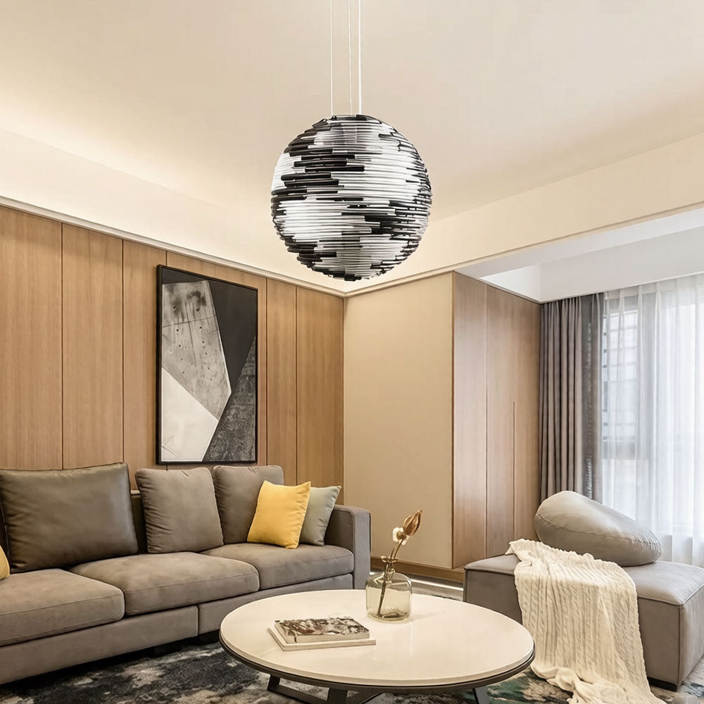 Glass globe hanging lamp illuminating a living room with soft diffused light