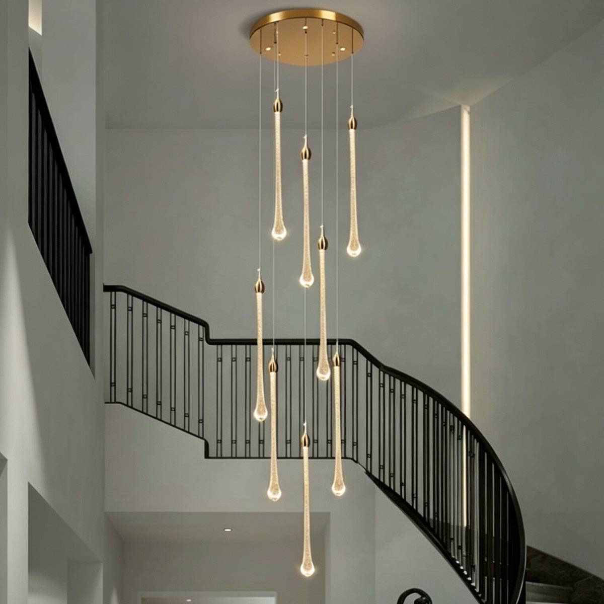Minimalist multi-tier bubble crystal pendant light over contemporary entryway staircase with iron balustrades