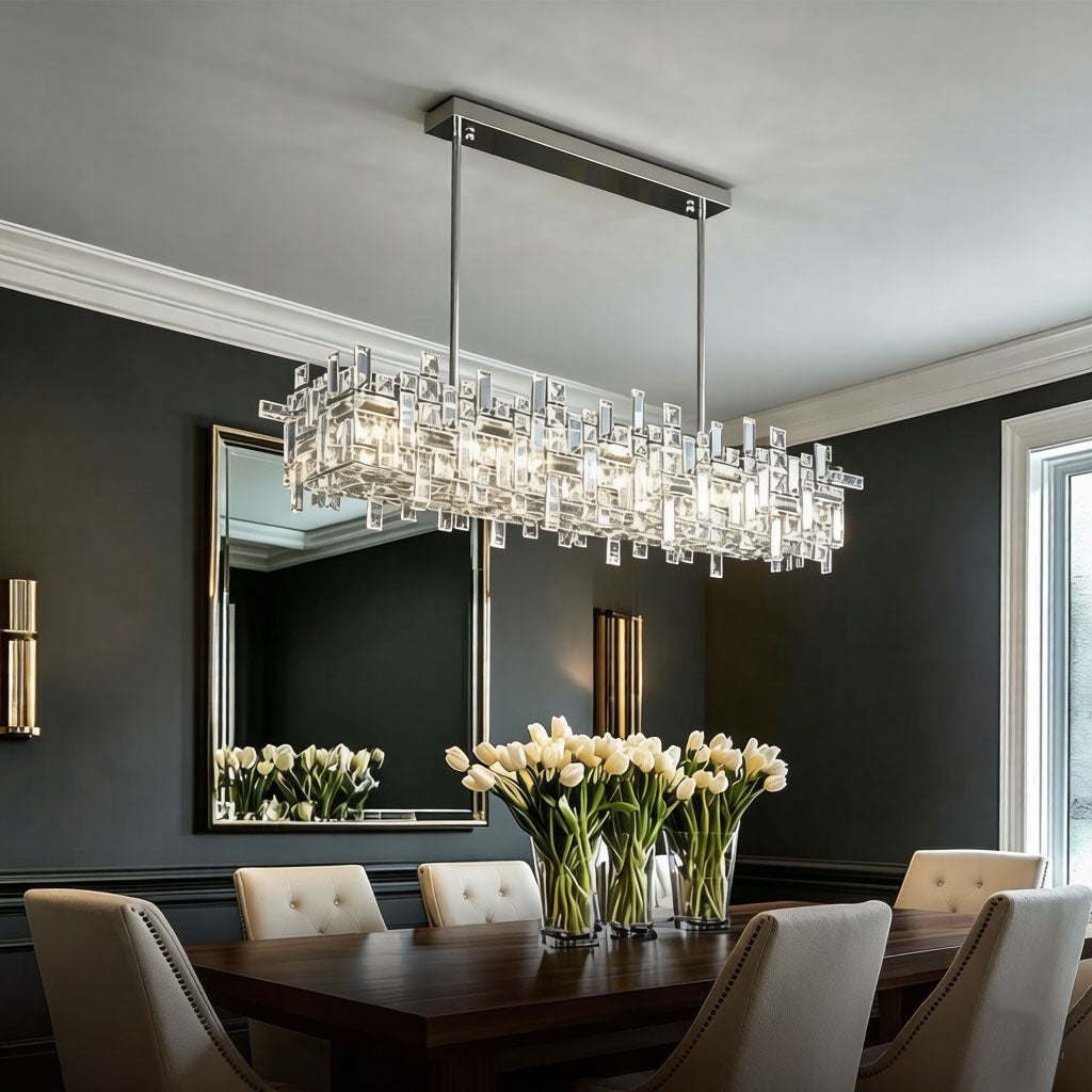 Luxury Linear Crystal Chandelier installed above kitchen sink area in modern white kitchen, chrome linear crystal pendant light, warm ambient lighting for contemporary home interior