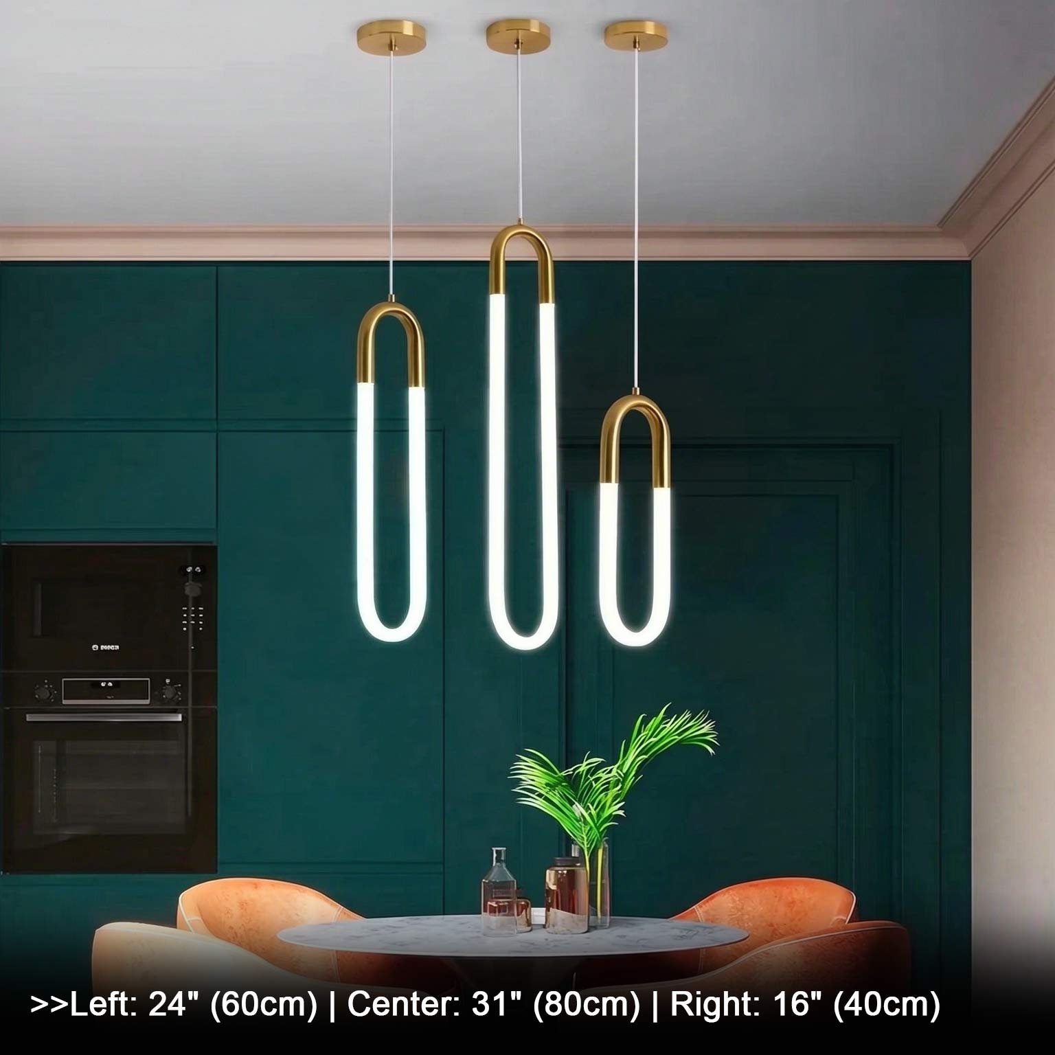 Three minimalist U-shaped gold pendant lights against dark green background with plant decor, brass finish white jade glass LED hanging lamps, modern interior accent lighting scene