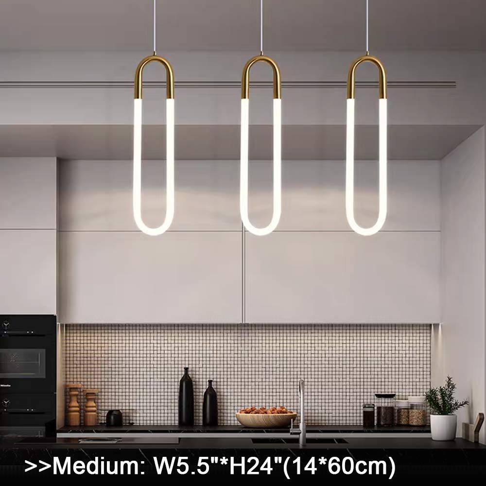 Three minimalist U-shaped gold pendant lights in a row, staggered height arrangement, brass finish white jade glass LED hanging lamps, modern dining room or living room pendant lighting scene