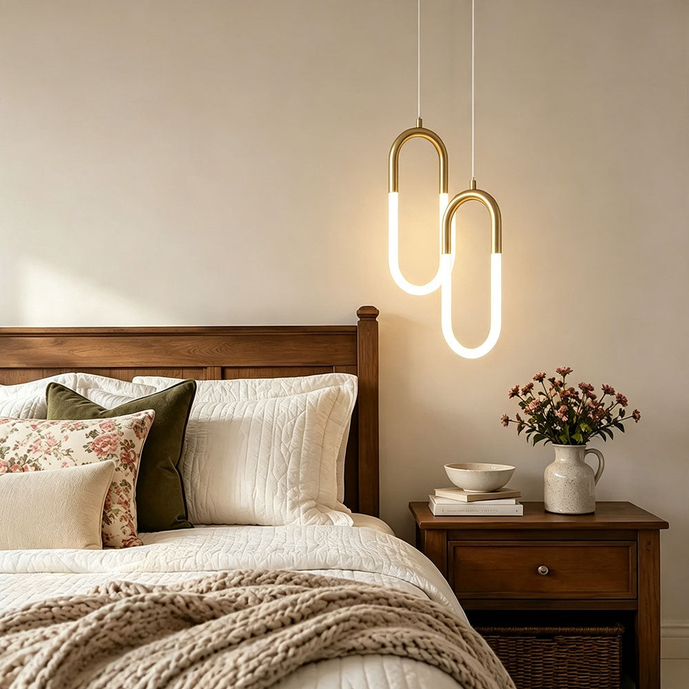 Gold U‑Shaped pendant light 2‑lights staggered combination, dual LED hanging lamps beside bedside, modern warm‑tone bedroom interior render