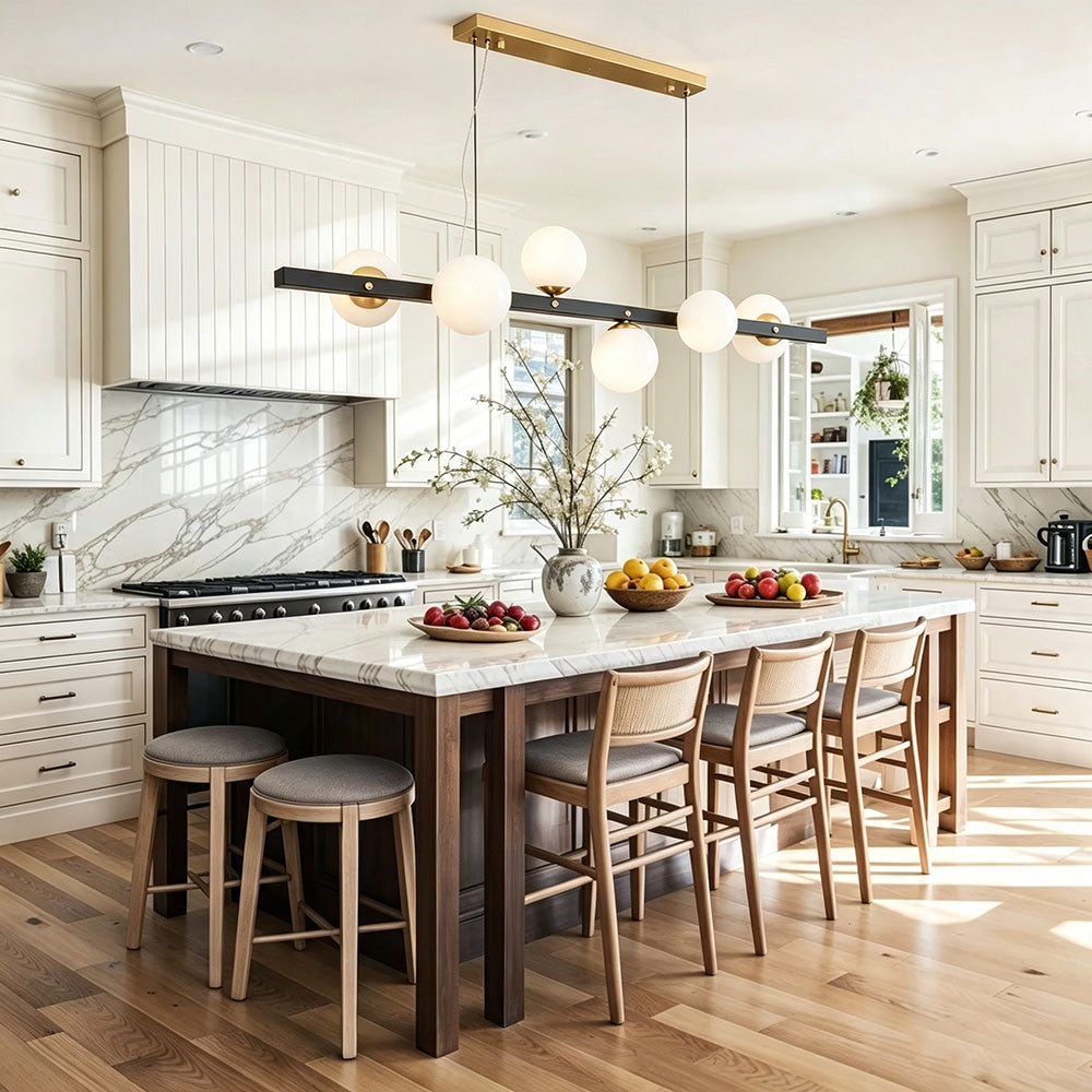 modern black gold linear globe chandelier above large kitchen island, opal frosted glass shades, two‑tone metal pendant light for luxury farmhouse kitchen interior