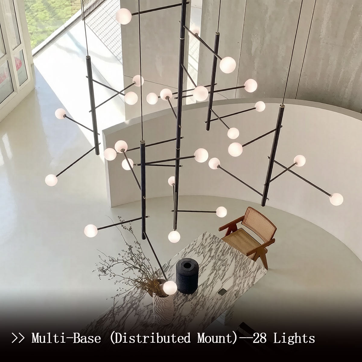 Industrial black chandelier installed in a double-height foyer with warm LED glow