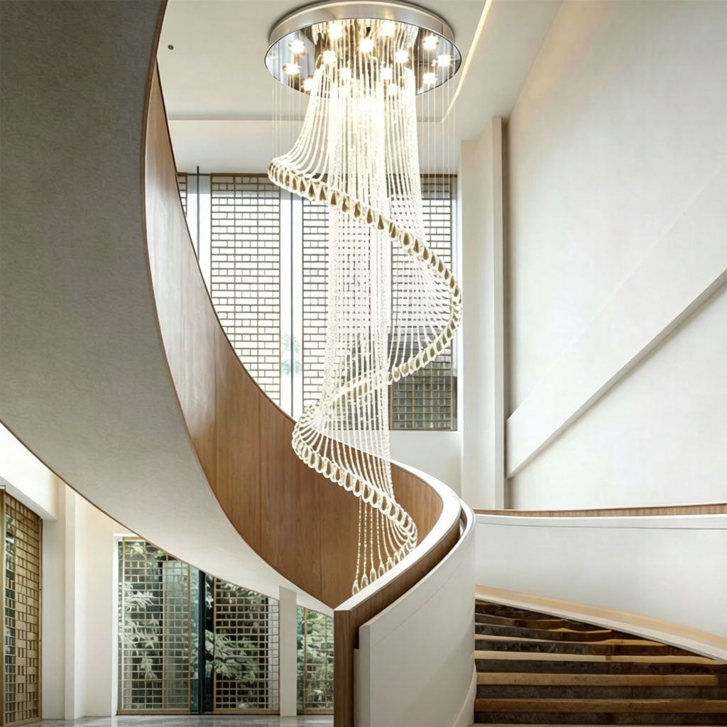 Luxury spiral crystal chandelier installed in a high-ceiling hotel lobby or villa entryway